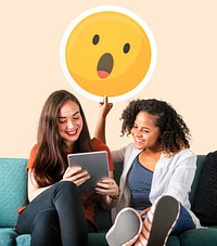 Women showing surprise emoticon and using tablet