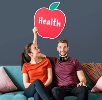 Cheerful couple holding a healthy apple icon
