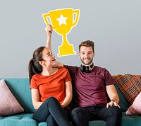 Cheerful couple holding a trophy icon