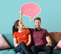 Cheerful couple holding a pink speech bubble icon