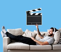 Male on a couch holding a clapper icon