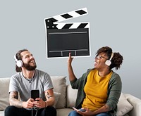 Interracial couplePeople on a couch holding a clapper