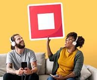 Interracial couple listening to music and holding a stop button