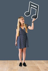 Woman holding a musical note in a studio