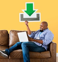 Man using a laptop and holding a download icon