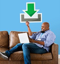 Man using a laptop and holding a download icon