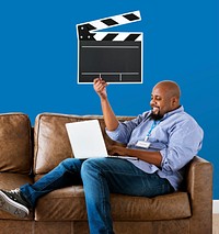 Man using a laptop and holding a clapper icon
