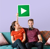 Young couple holding a play button icon