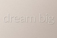 Dream big embossed font white paper background