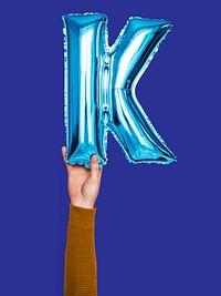 Hand holding balloon letter K