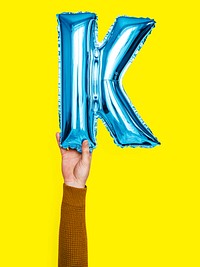 Hand holding balloon letter K