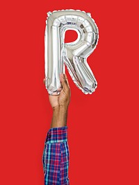 Hand holding balloon letter R