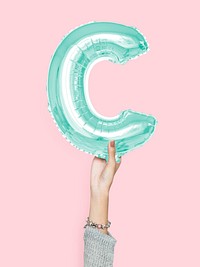 Hand holding balloon letter C