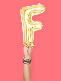 Hand holding balloon letter F