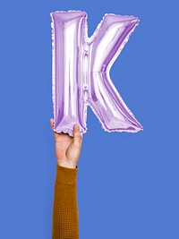 Hand holding balloon letter K