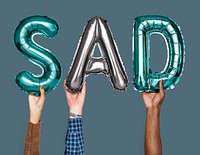 Hands showing sad balloons word