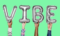 Gray silver alphabet balloons forming the word vibe