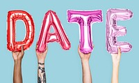 Pink alphabet balloons forming the word date