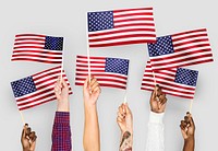 Hands waving flags of the United States