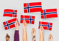 Hands waving flags of Norway