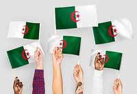 Hands waving flags of Algeria