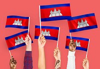 Hands waving flags of Cambodia