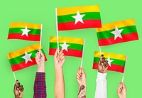 Hands waving flags of Myanmar