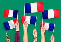Hands waving the flags of France