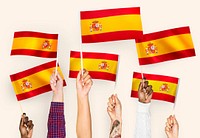 Hands waving the flags of Spain