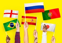 Hands raising national flags of England, Spain, Japan, Portugal, Russia, and Brazil