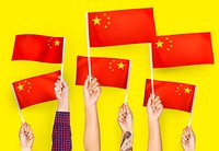 Hands waving flags of China