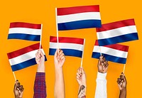 Hands waving flags of the Netherlands