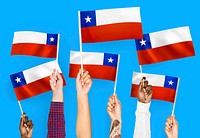 Hands waving flags of Chile