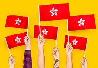 Hands waving flags of Hong Kong