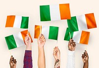 Hands waving flags of Ireland