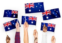 Hands waving the flags of Australia
