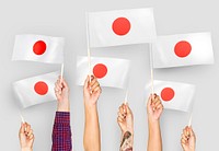 Hands waving the flags of Japan