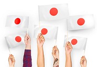 Hands waving the flags of Japan