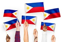Hands waving flags of the Philippines