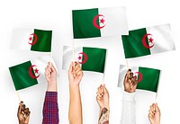 Hands waving flags of Algeria