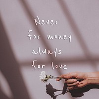 Never for money always for love quote on a hand holding flower background