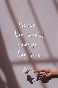 Never for money always for love quote on a hand holding flower background