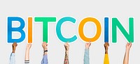 Hands holding up colorful letters forming the word bitcoin