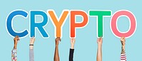 Hands holding up colorful letters forming the word crypto
