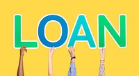 Hands holding up colorful letters forming the word loan
