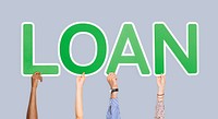 Hands holding up green letters forming the word loan