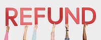 Hands holding up red letters forming the word refund<br />