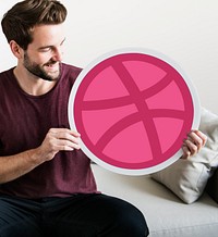Person holding a Dribbble icon