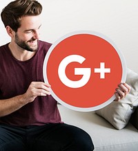 Person holding a Google Plus icon