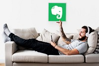 Person holding an Evernote icon